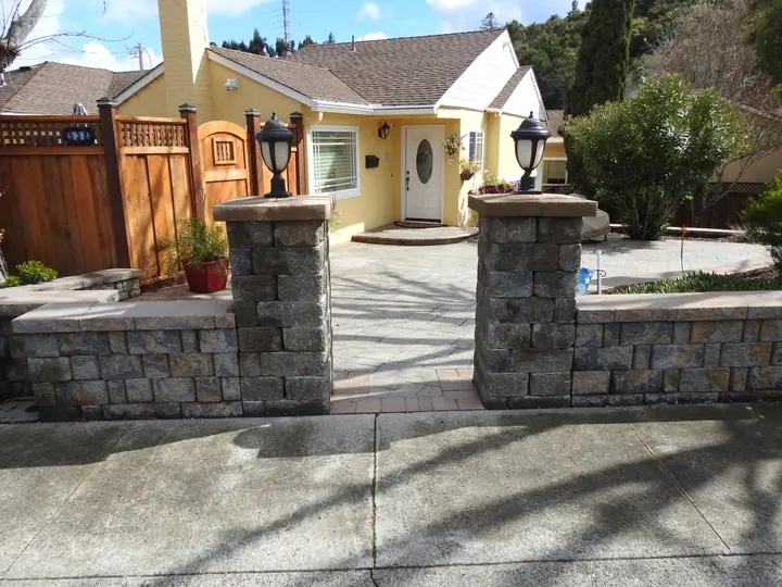 Landscape Lighting Lit Stone Pillars At The Front Entry