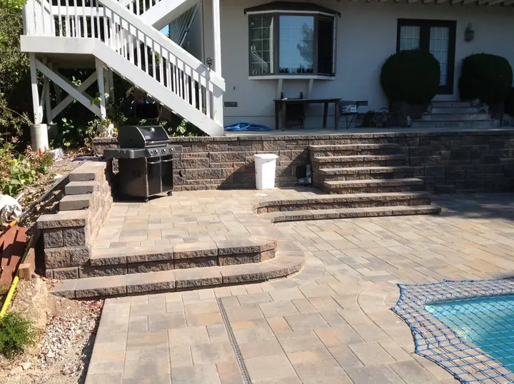 Outdoor Kitchen Masonry Raised Bbq Platform Above A Paver Pool Deck