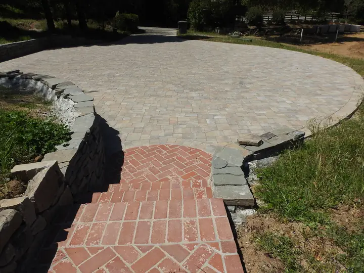 Patio Paving Round Brick Patio With A Stone Wall