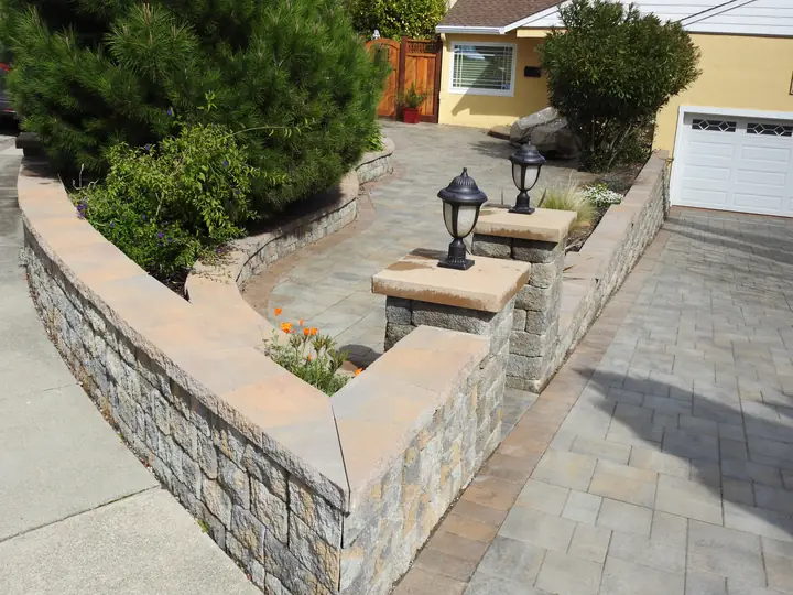 Retaining Wall Construction Stone Faced Wall Beside A Paver Drive